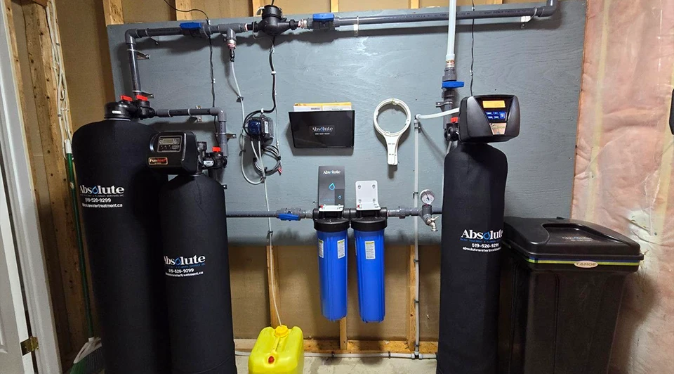 Compact Deluxe Springfield Special water treatment system installed in a basement utility space in Aylmer, Ontario